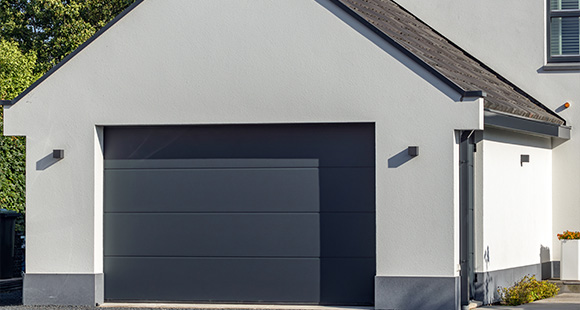 modern garage exterior design with sleek gray door and white walls showcasing contemporary architecture for five car storage